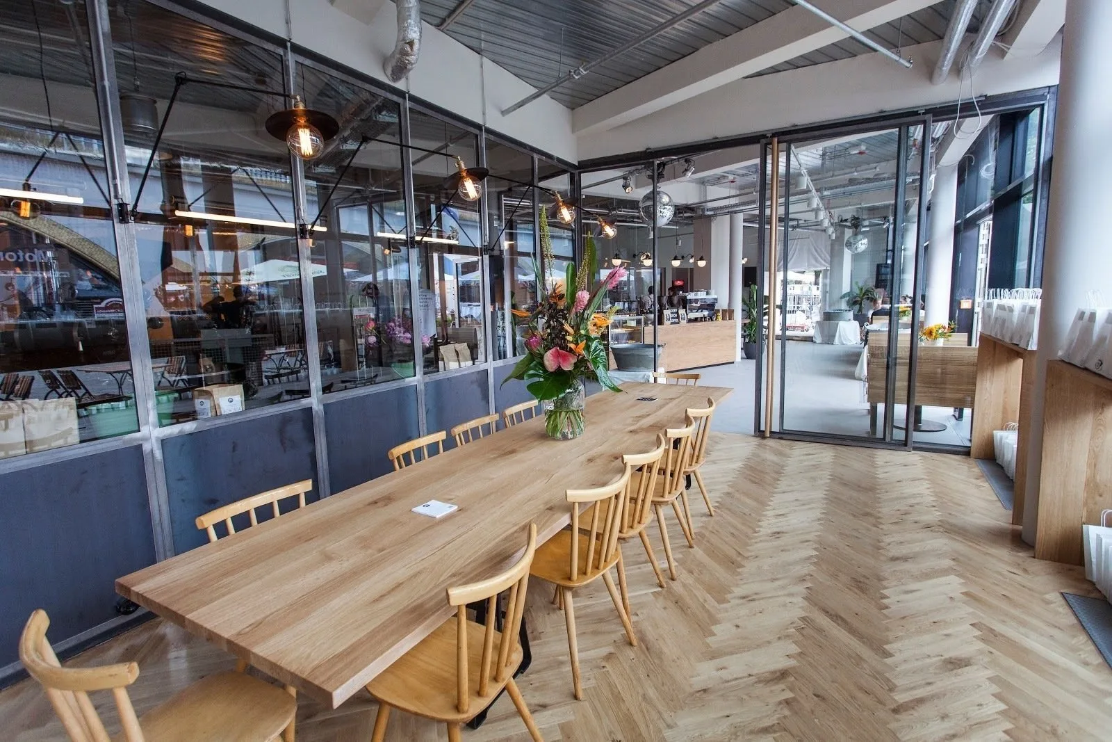 modern office or café space with wooden table, chairs, and glass partitions., 19grams alex – coffee roastery, berlin