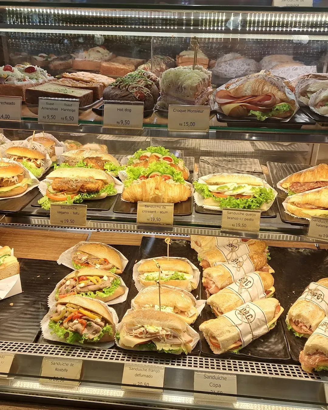 refrigerated bakery display case filled with fresh sandwiches and prepared food items., 89ºc coffee station, são paulo