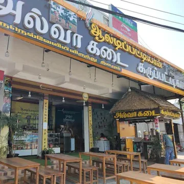 tamil restaurant storefront with wooden tables and yellow signage displayed outside., aaladipattiyan kaiveli, chennai