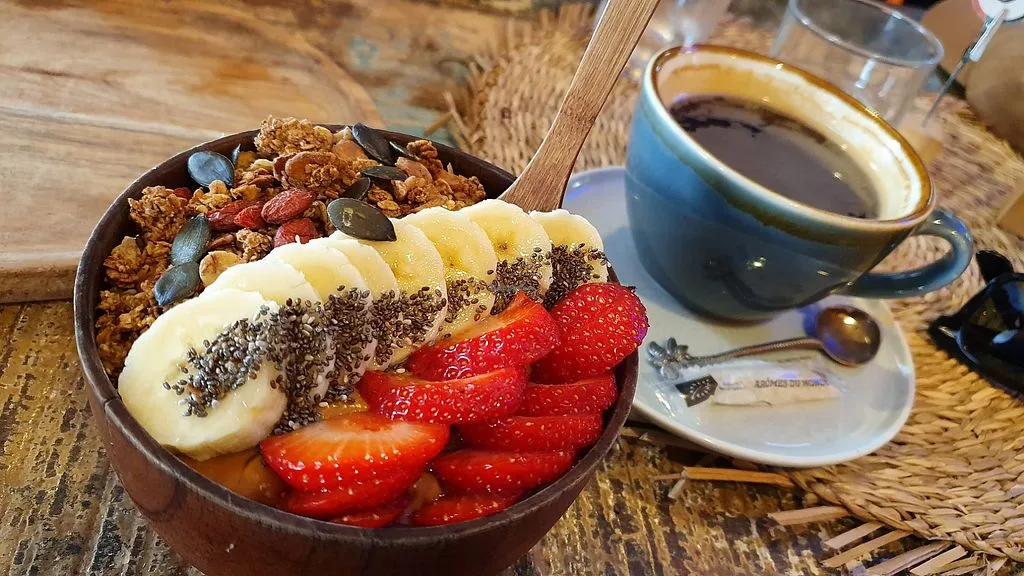 breakfast bowl with granola, strawberries, banana slices, chia seeds, and coffee., acai and you - maubeuge | all week brunch 