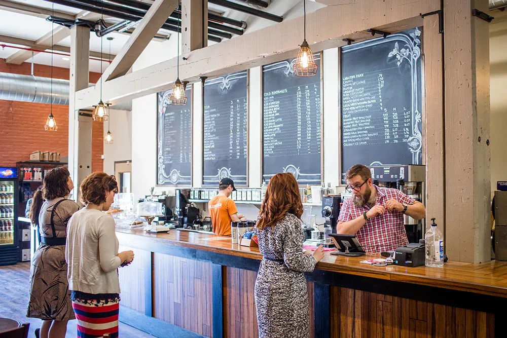 modern coffee shop interior with menu boards, customers ordering, and pendant lighting., acoustic java, worcester