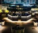 modern upscale bar lounge with warm lighting and elegant curved seating arrangements., air bistro, ahmedabad