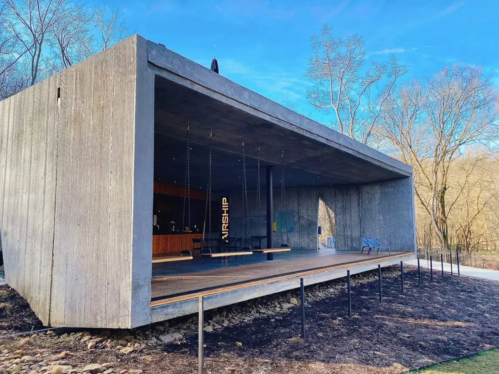 modern architectural pavilion with open front and wooden deck platform., airship coffee at coler, bentonville
