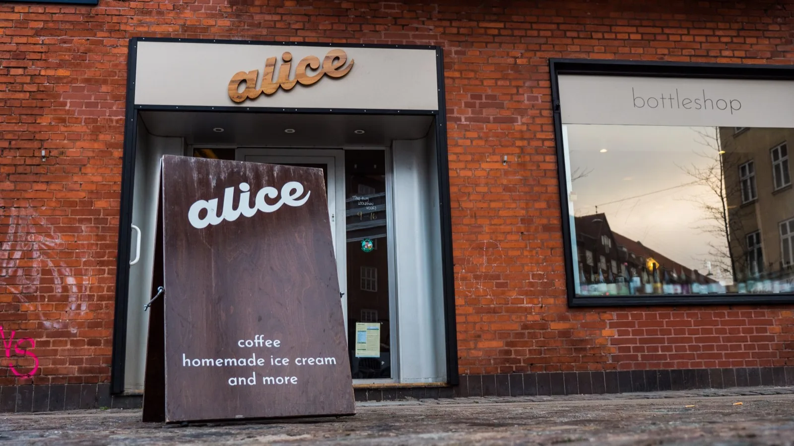 brick storefront with "alice" café sign offering coffee, homemade ice cream and more., alice, copenhagen
