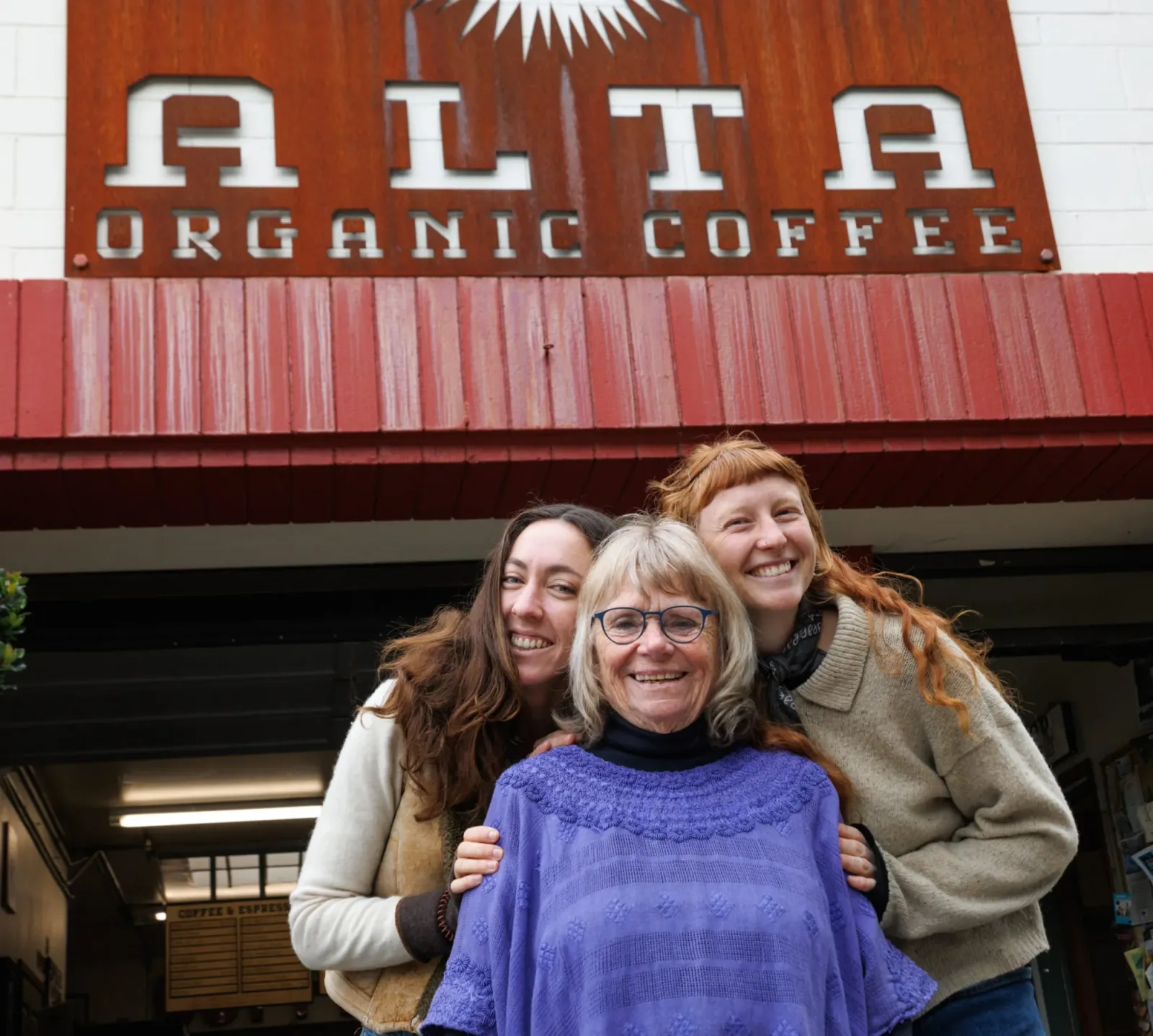 three women smiling in front of alta organic coffee storefront sign., alta organic coffee, santa cruz