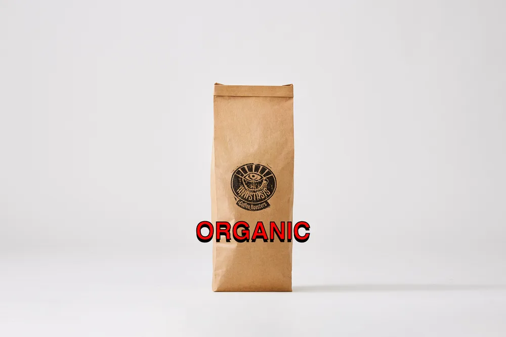 brown kraft paper coffee bag with circular logo and red "organic" text overlay., anastasis coffee roasters, auckland