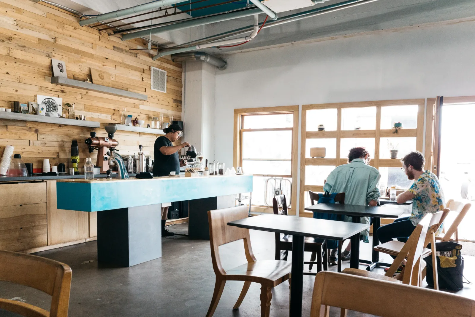modern cafe interior with wooden walls, counter service, and customers seated at tables., anthology coffee, detroit