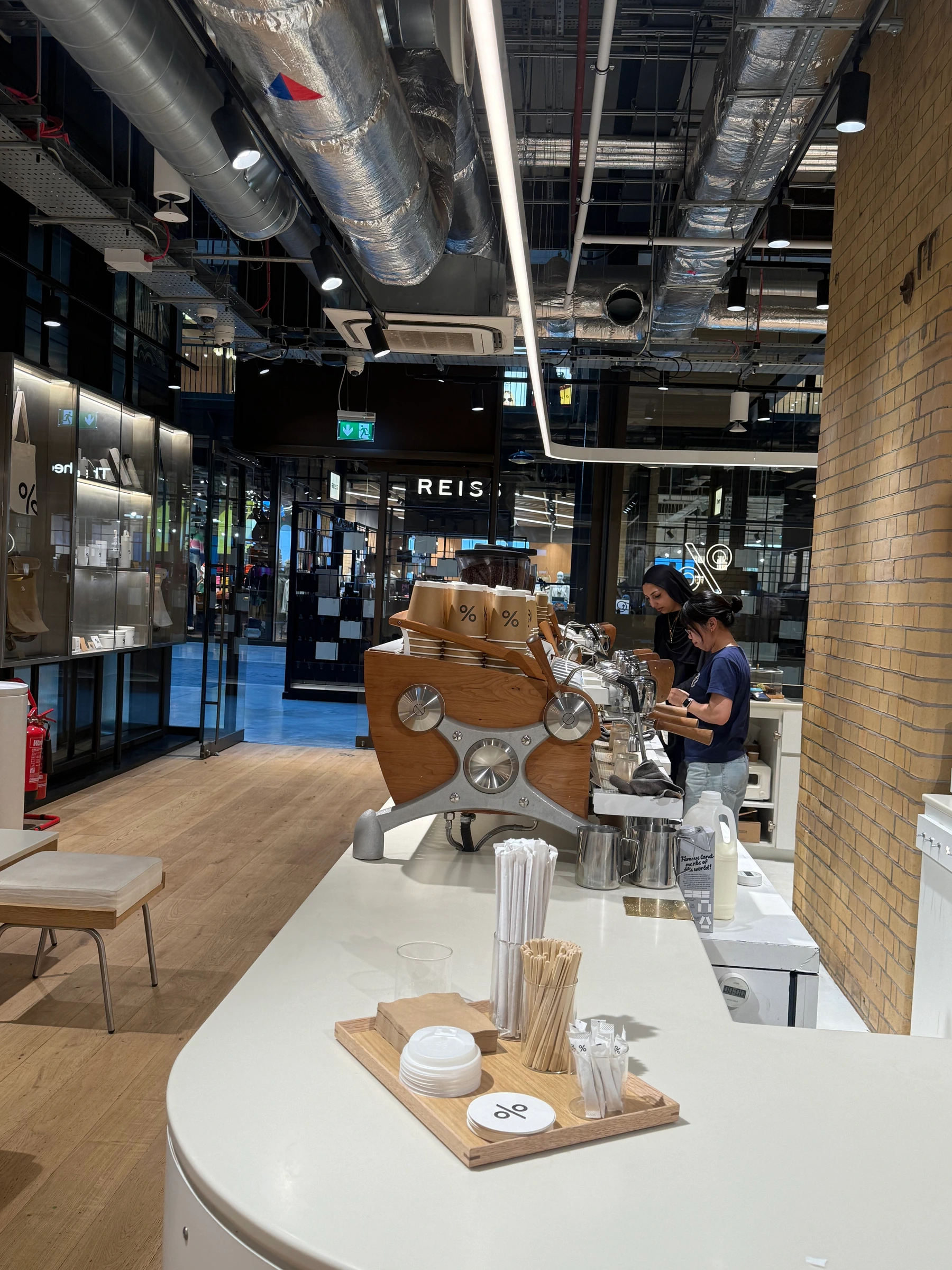 interior of %arabica battersea, white tile and white counter under the chimneys, london sw11