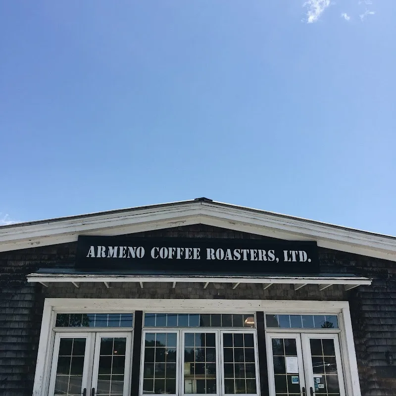 black wooden storefront with white trim doors displaying "armeno coffee roasters, ltd." signage., armeno coffee roasters, nor