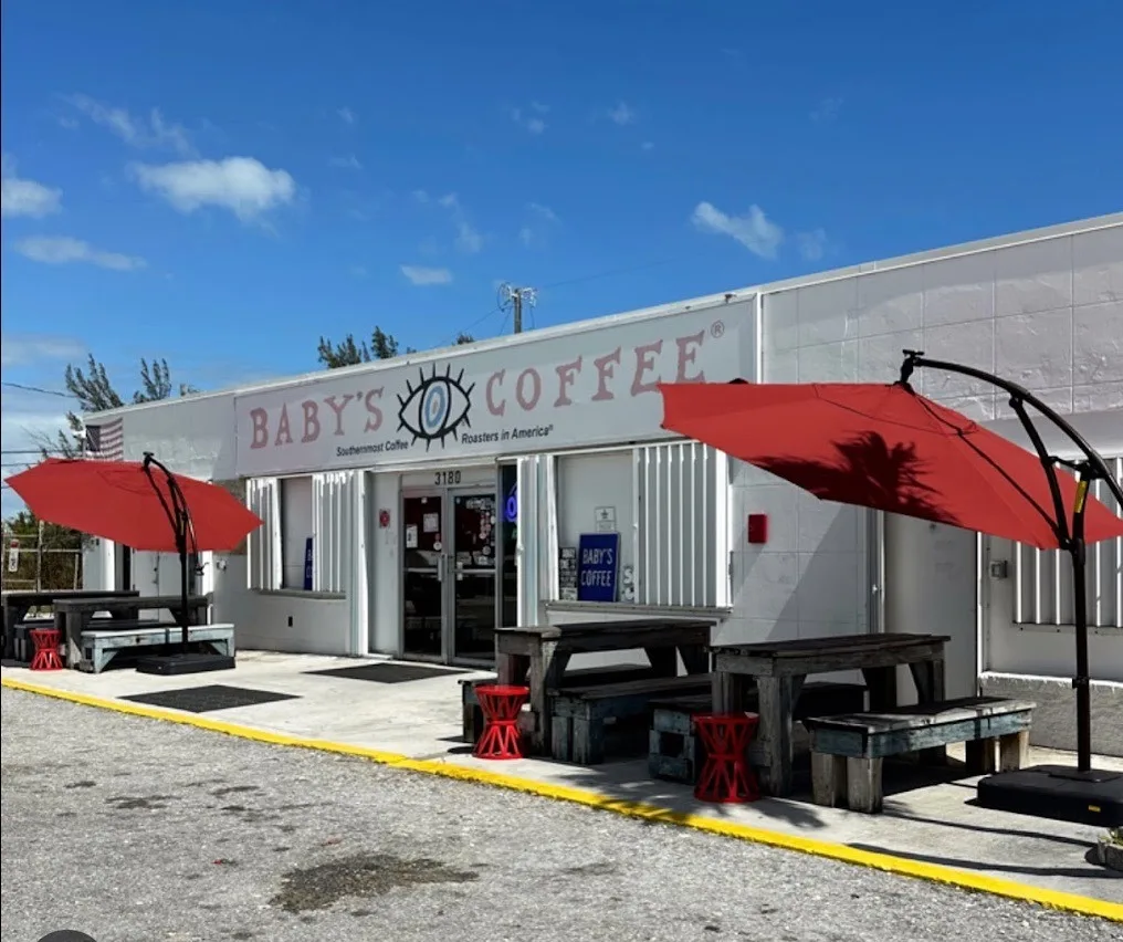 baby's coffee shop storefront with red umbrellas and outdoor seating area., baby's coffee, key west