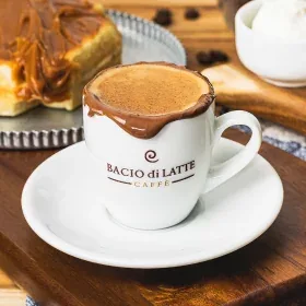 bacio di latte coffee cup with latte art on wooden table setting., bacio di latte, niterói
