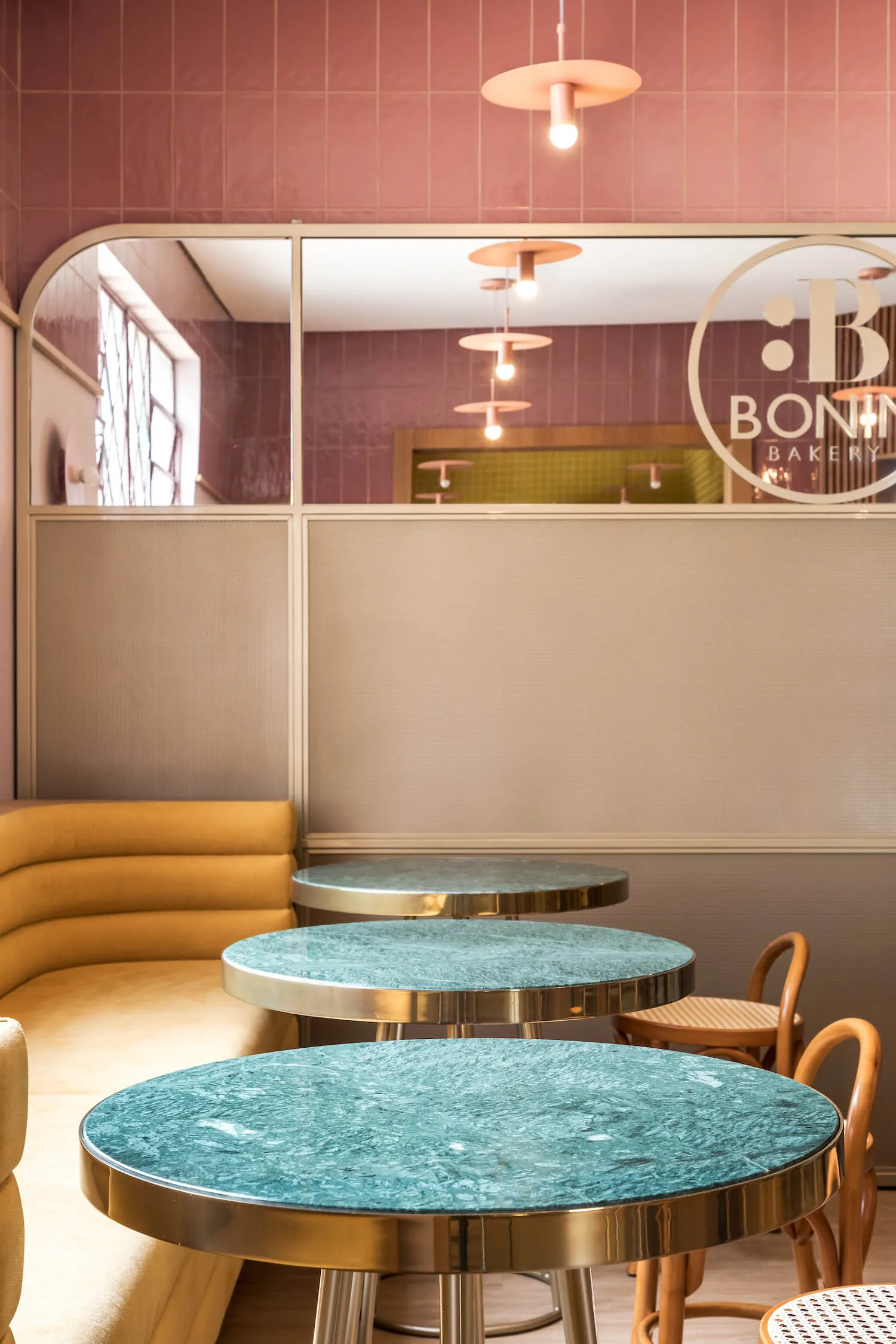 modern bakery interior with turquoise marble tables and brass accents., bakery via veneto, curitiba
