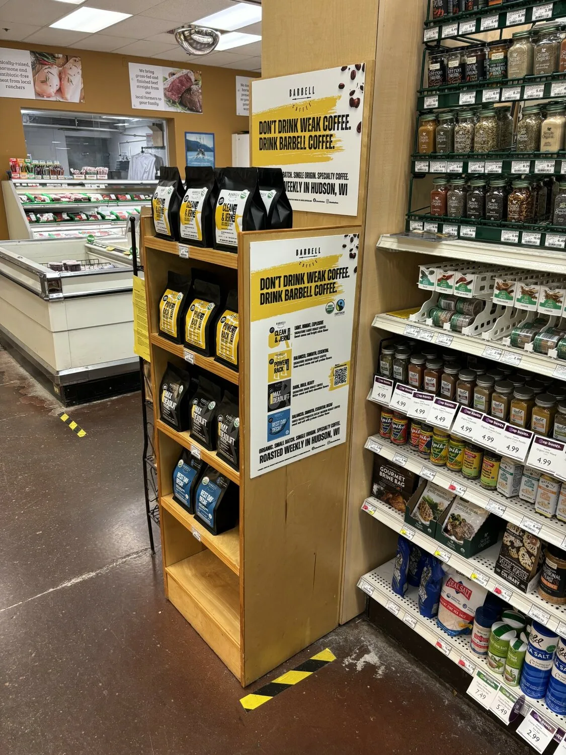 specialty coffee display with yellow signage in grocery store aisle., barbell coffee company, hudson