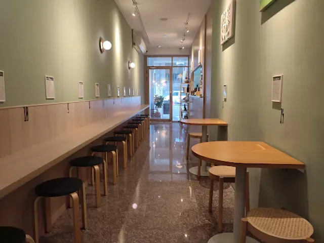 modern café interior with counter seating, wooden tables, and minimalist green walls., barbican 望樓（高雄必訪寶藏店家/寵物聚會友善/手路菜餐酒/附有兒童