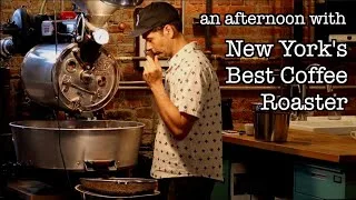 coffee roaster working with large roasting drum in rustic shop interior., barro coffee roasters, new york city