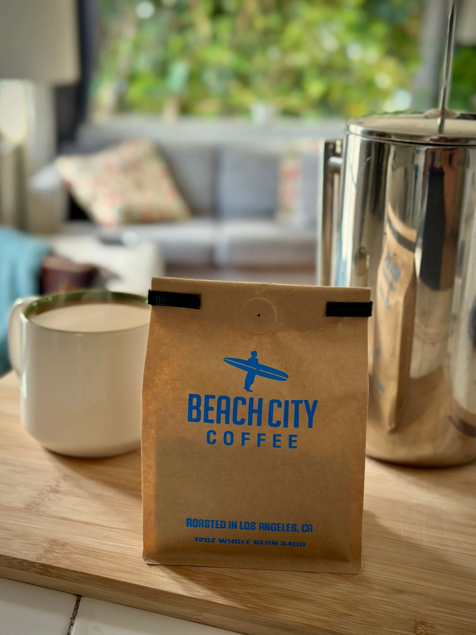 beach city coffee bag with mug and metal pitcher on wooden table., beach city coffee, los angeles