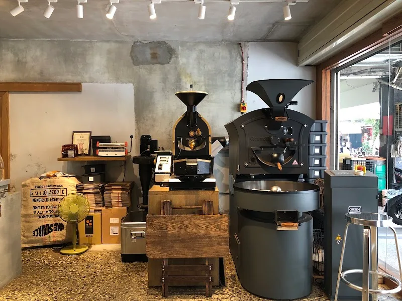 coffee roasting facility with industrial roasters, grinders, and equipment displayed., bean barn 豆荒良倉 (最後點餐5pm), taipei