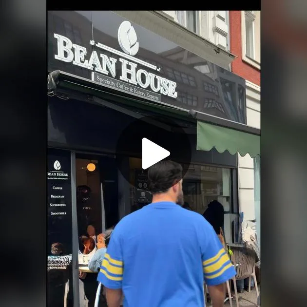 person in blue shirt approaching bean house specialty coffee and bakery storefront., bean house, berlin