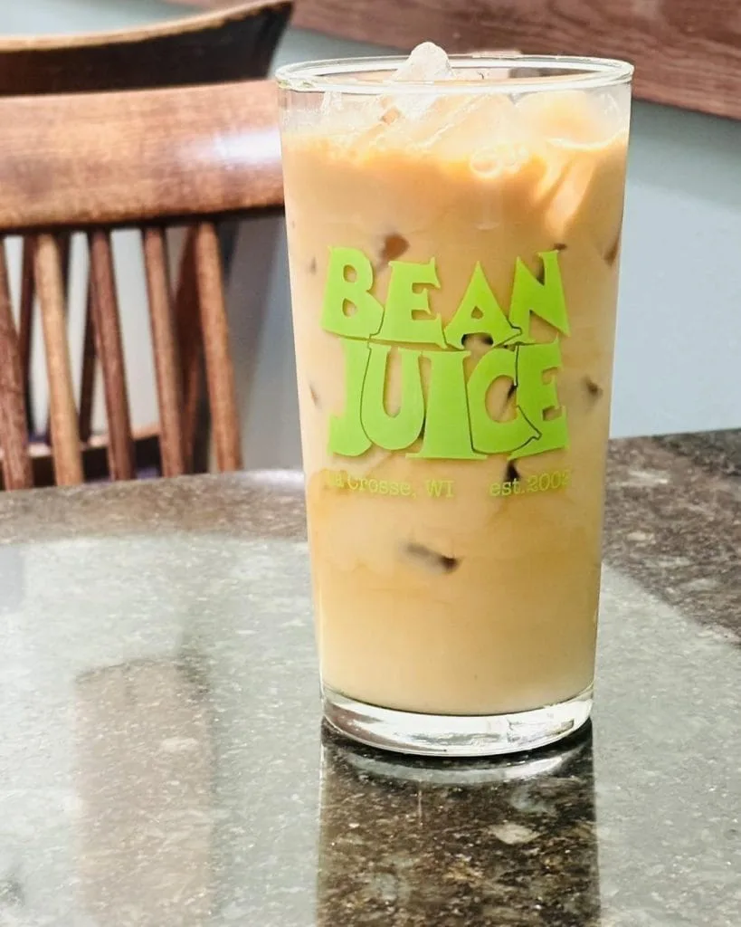 bean there coffee drink with lime green logo on glass counter., bean juice coffee roasters, wisconsin