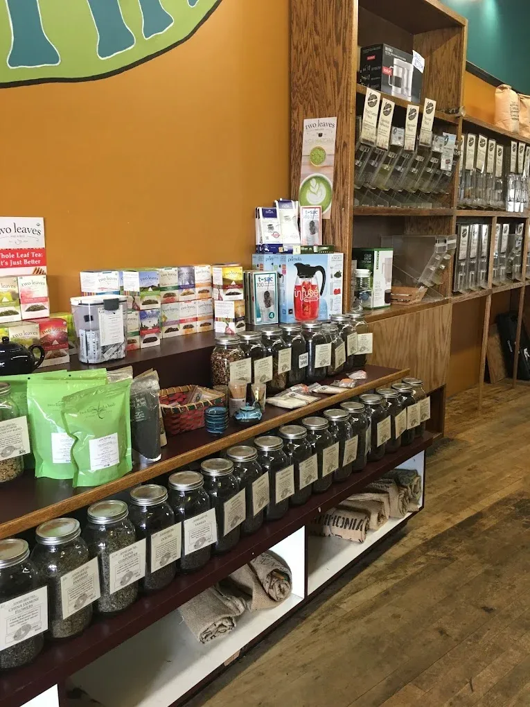 tea shop retail display with jars, boxes, and packaged products on wooden shelving., bean werks coffee & tea, asheville