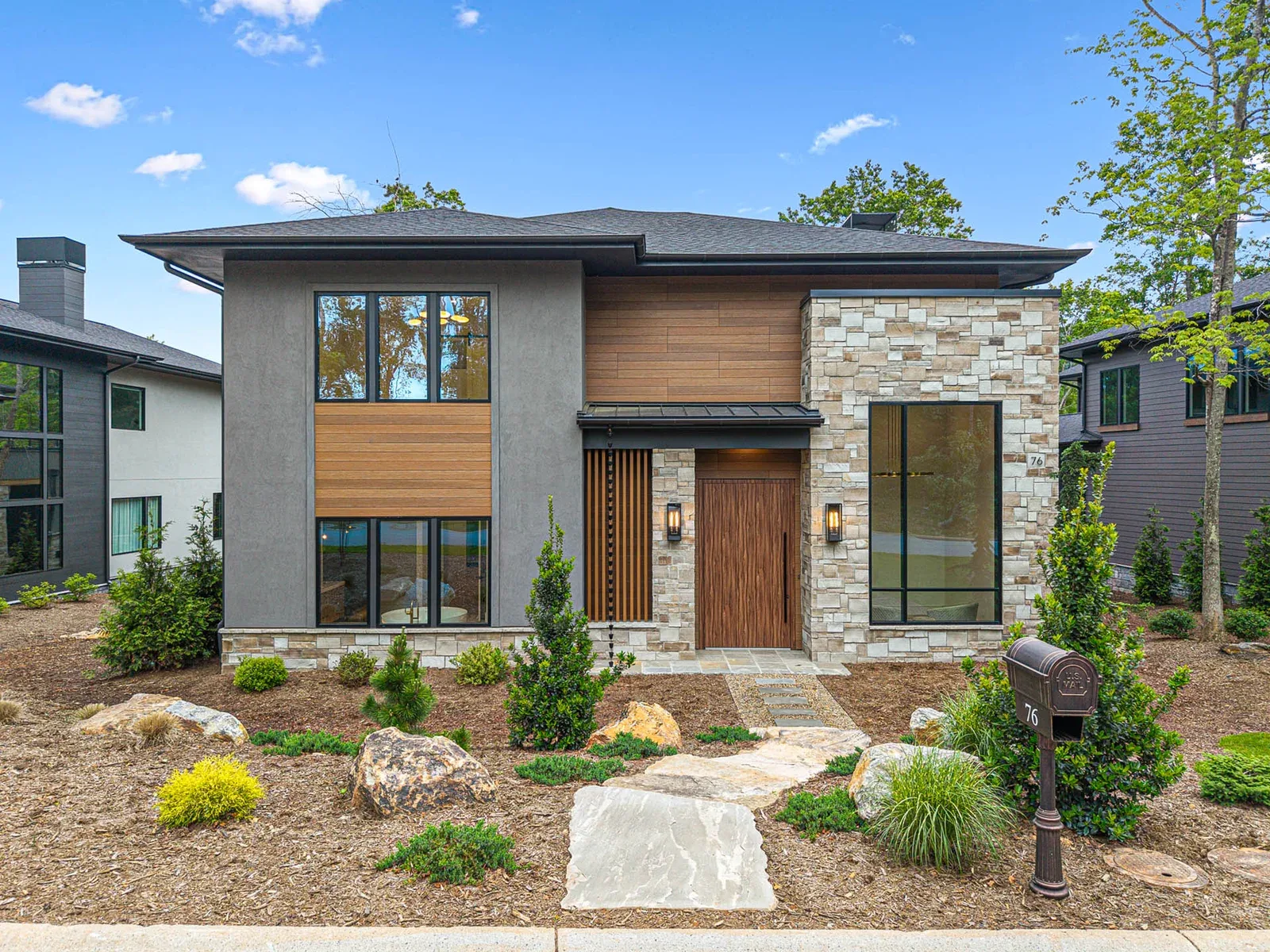 modern two-story home with stone exterior, wood accents, and landscaped front yard., bean werks coffee & tea, asheville