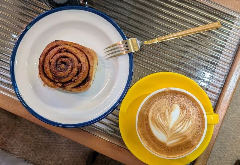 cinnamon roll on white plate with fork beside latte art coffee in yellow cup., beangood café 冰穀咖啡草悟店（實際營業時間依店家fb&ig公告為主）, tai