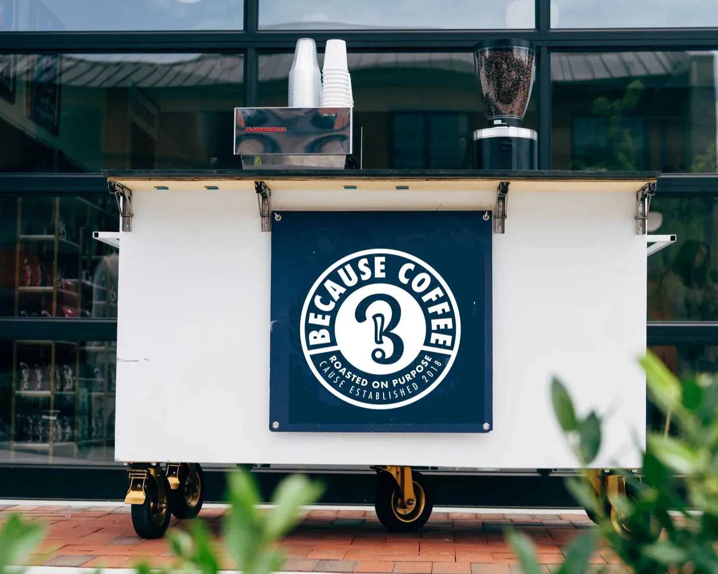 because coffee mobile cart with logo, cups, napkins, and grinder displayed., because coffee, atlanta