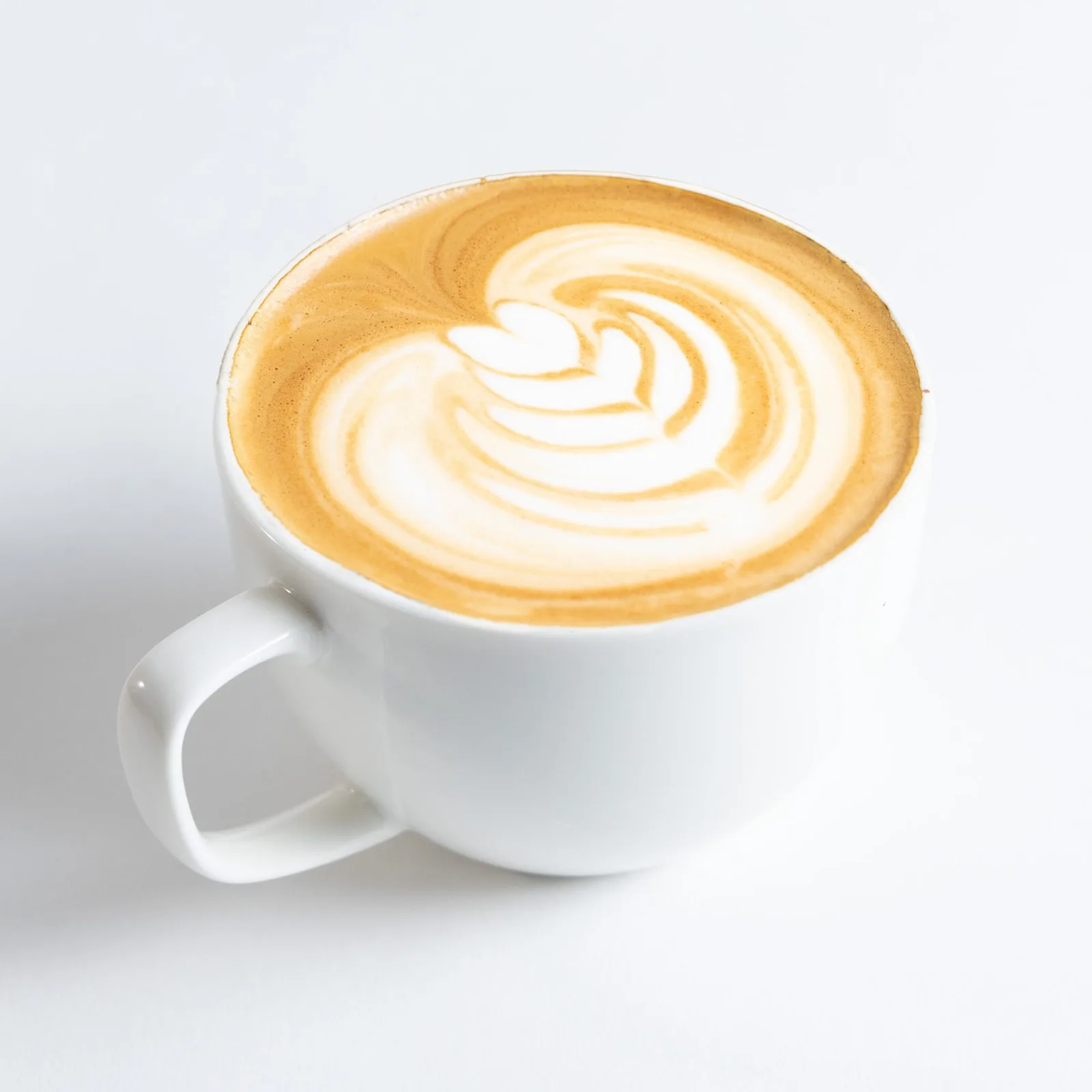 white ceramic cup containing cappuccino with decorative latte art design., beerline cafe, milwaukee