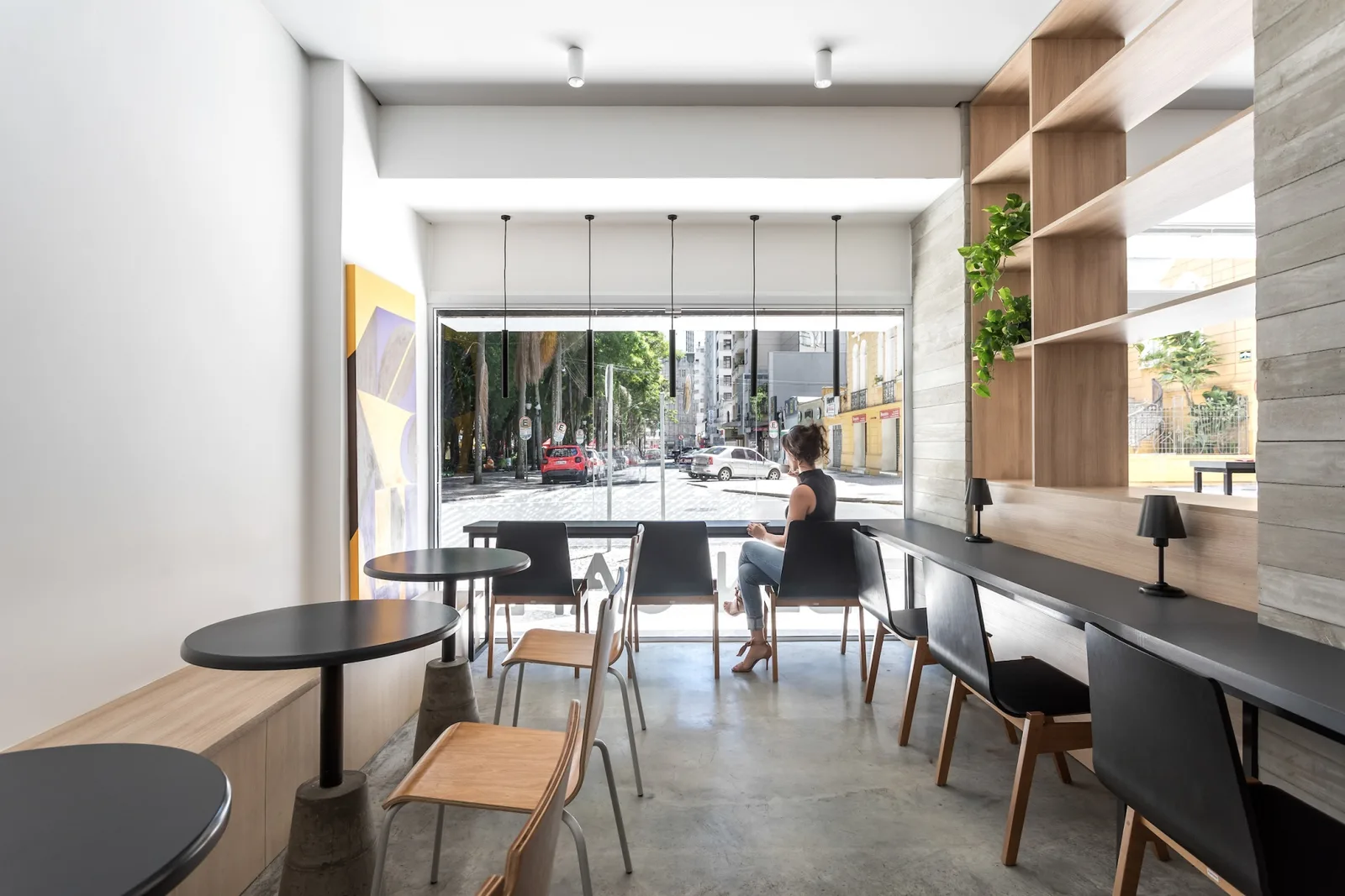 modern café interior with floor-to-ceiling windows overlooking urban street scene., ben café, curitiba
