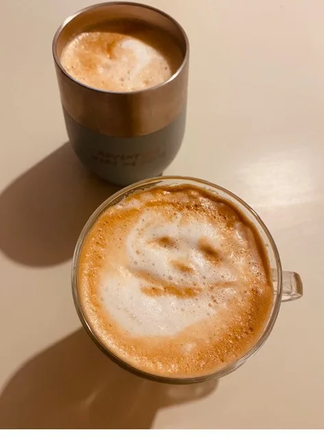 two coffee drinks with latte art on a beige surface, casting shadows., bennetti coffee roasters, melbourne