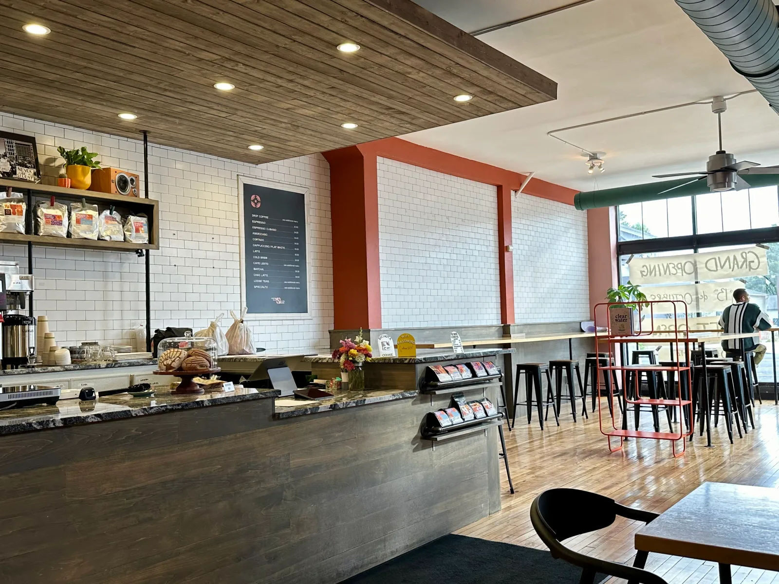 modern coffee shop interior with subway tile, wood ceiling, and rustic seating area., bichota coffee, minneapolis