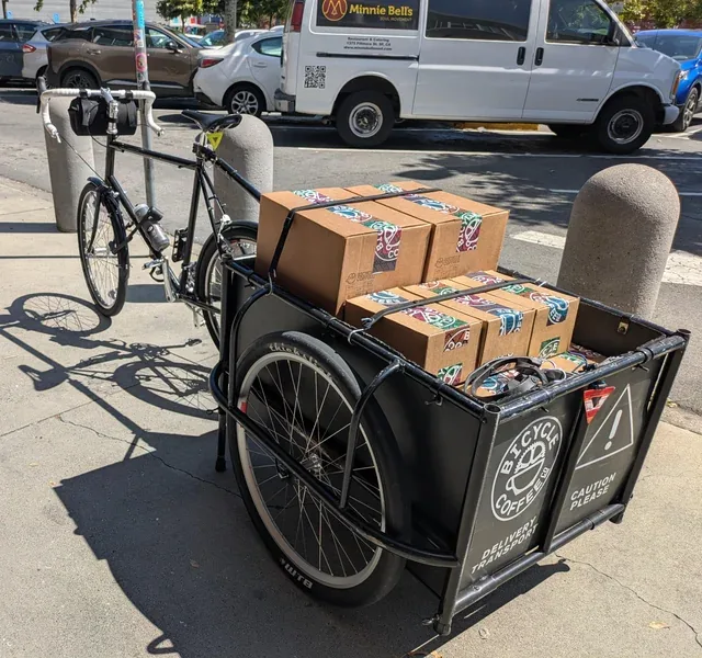 cargo bicycle with packaged goods parked on urban street., bicycle coffee, san francisco