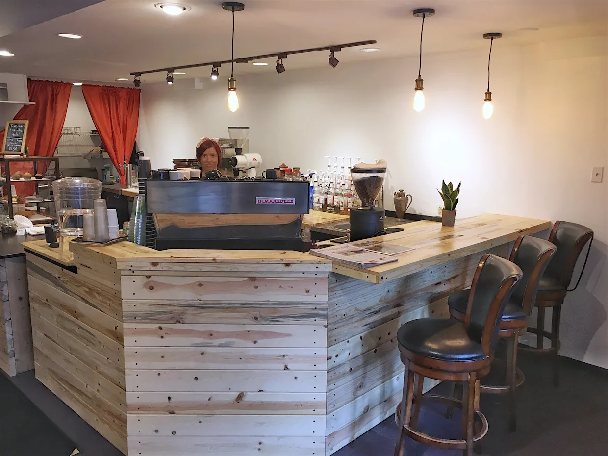 modern coffee shop interior with wooden counter and pendant lighting fixtures., big iron coffee co., steamboat springs