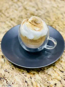 layered coffee dessert with whipped cream and gold leaf in glass cup on saucer., billie joe coffee co., dallas
