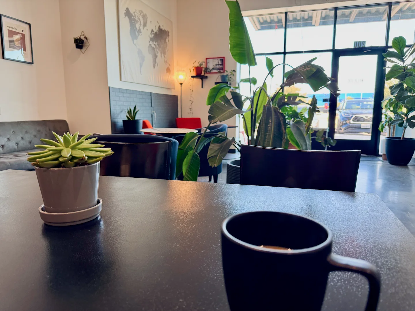 modern office break room with plants, mug, and city views through large windows., billie joe coffee co., dallas