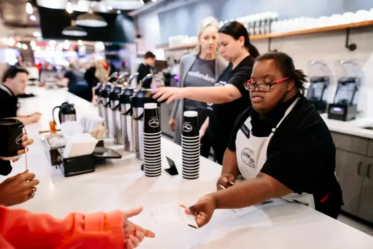 staff serving beverages at a busy coffee event or festival counter., bitty & beau’s coffee, savannah