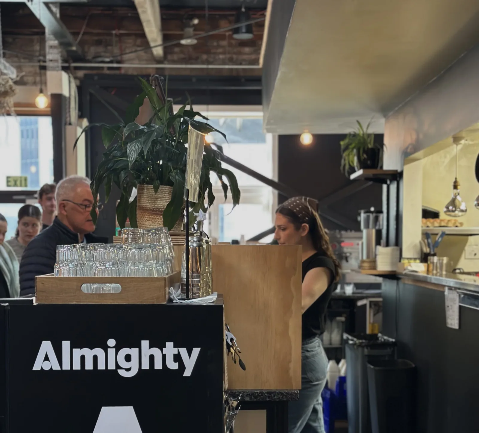 modern café interior with almighty branded counter, staff, plants, and customers., black betty cafe, christchurch
