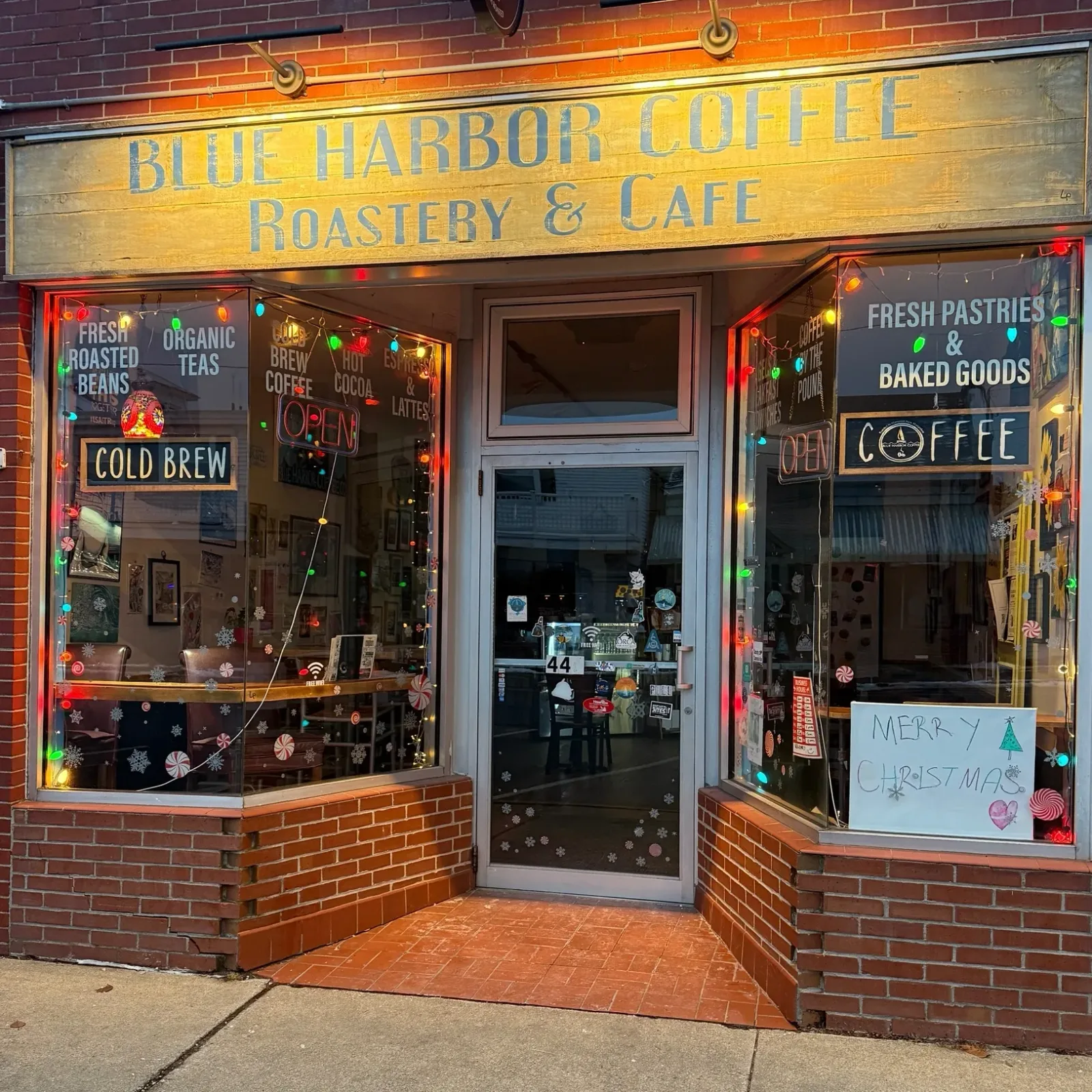 blue harbor coffee roastery & cafe storefront decorated with festive holiday lights and ornaments., blue harbor coffee, hampt