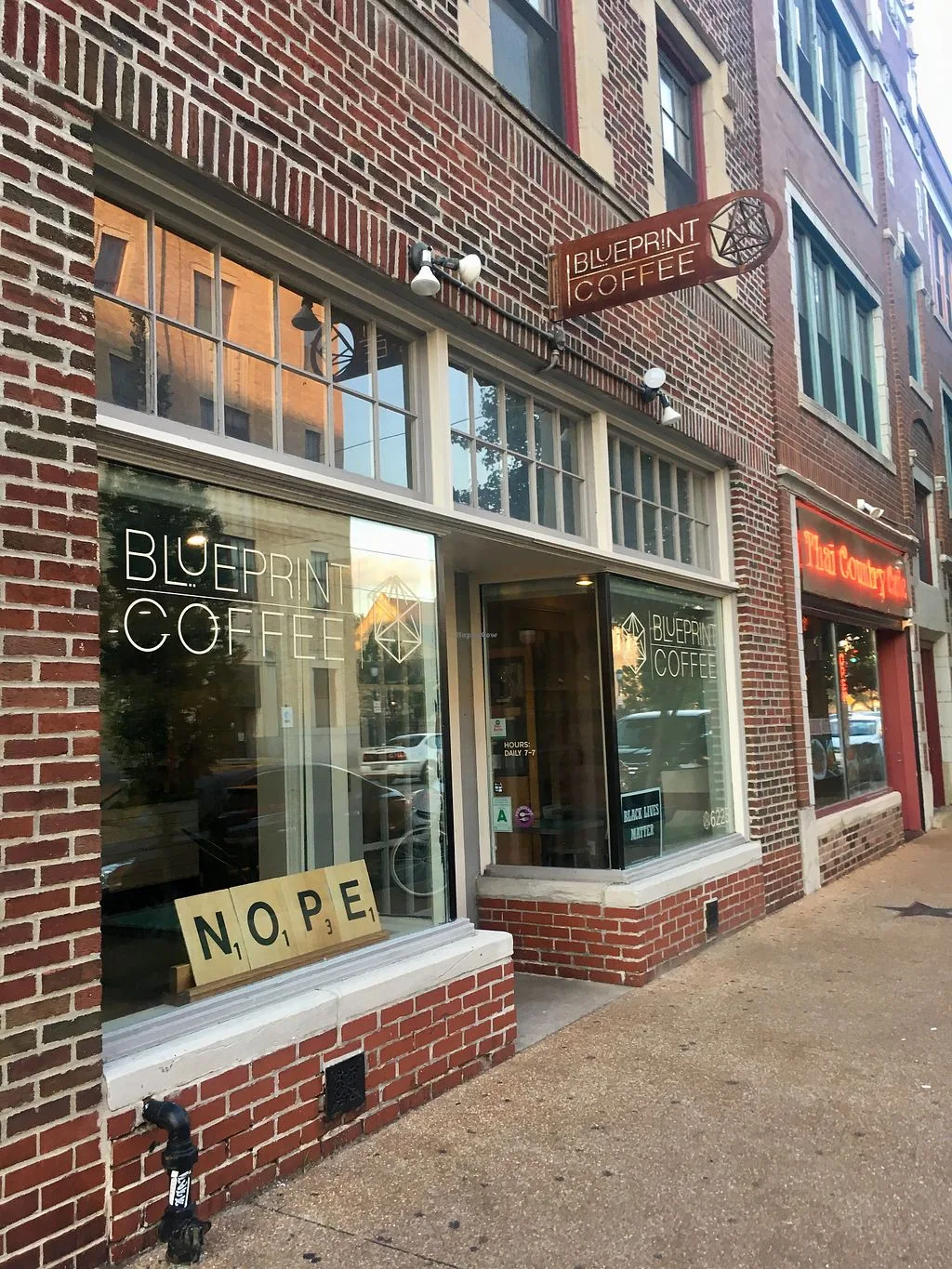 blueprint coffee storefront with "nope" sign displayed in window., blueprint coffee - delmar, st. louis