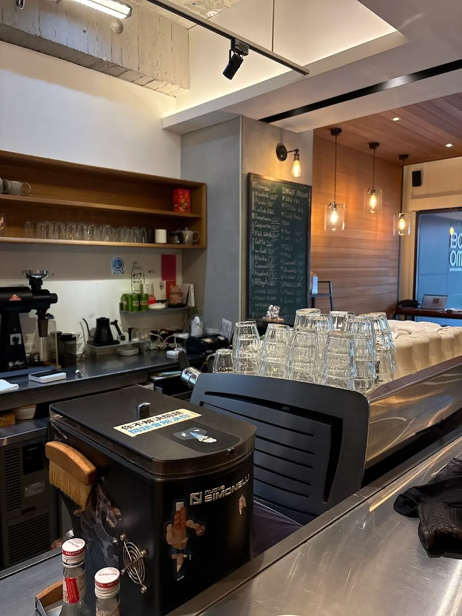 modern coffee shop interior with espresso machine, bar seating, and pendant lighting., bo coffee roaster, taipei