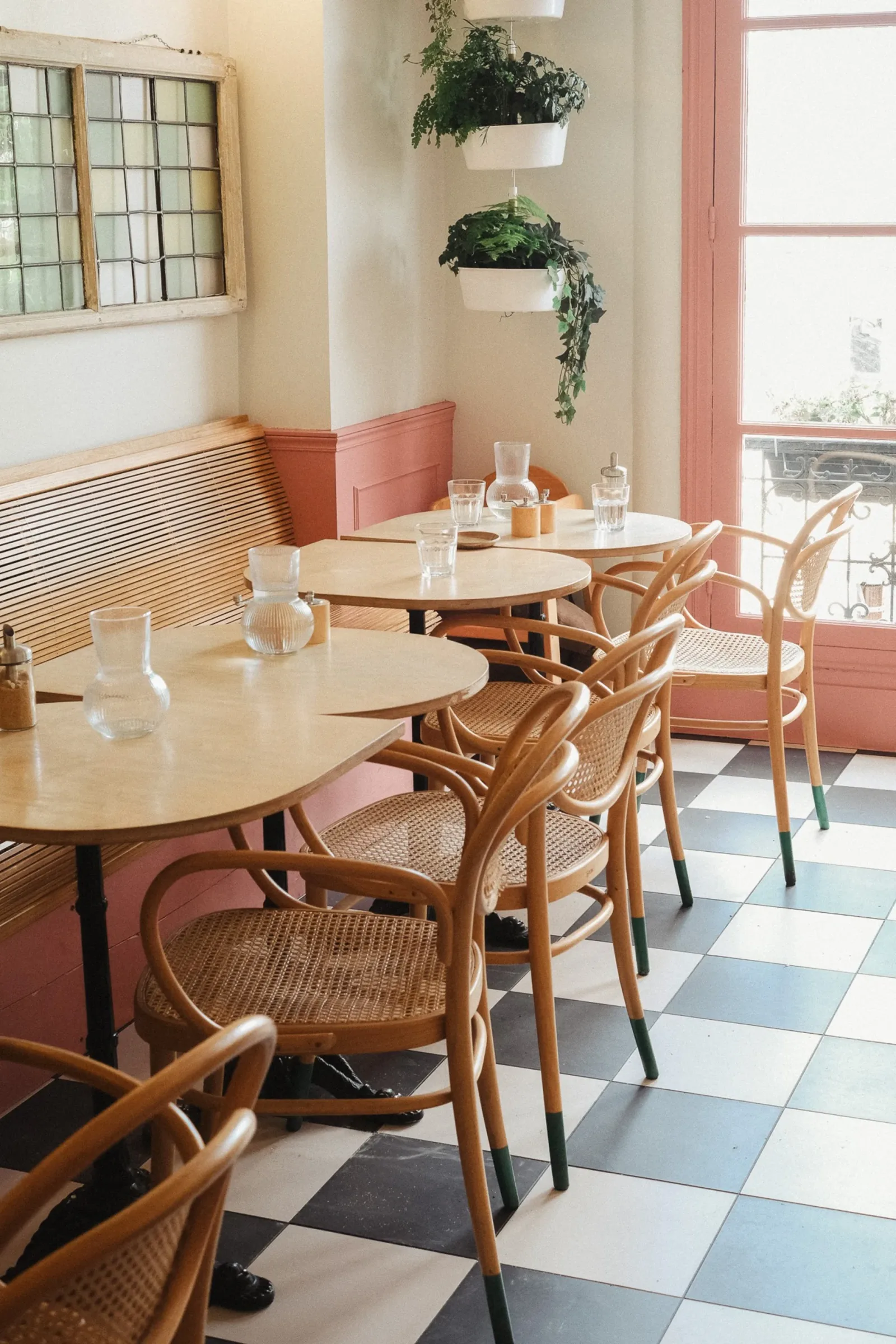 elegant café interior with wooden tables, woven chairs, and hanging plants., bon jo, paris