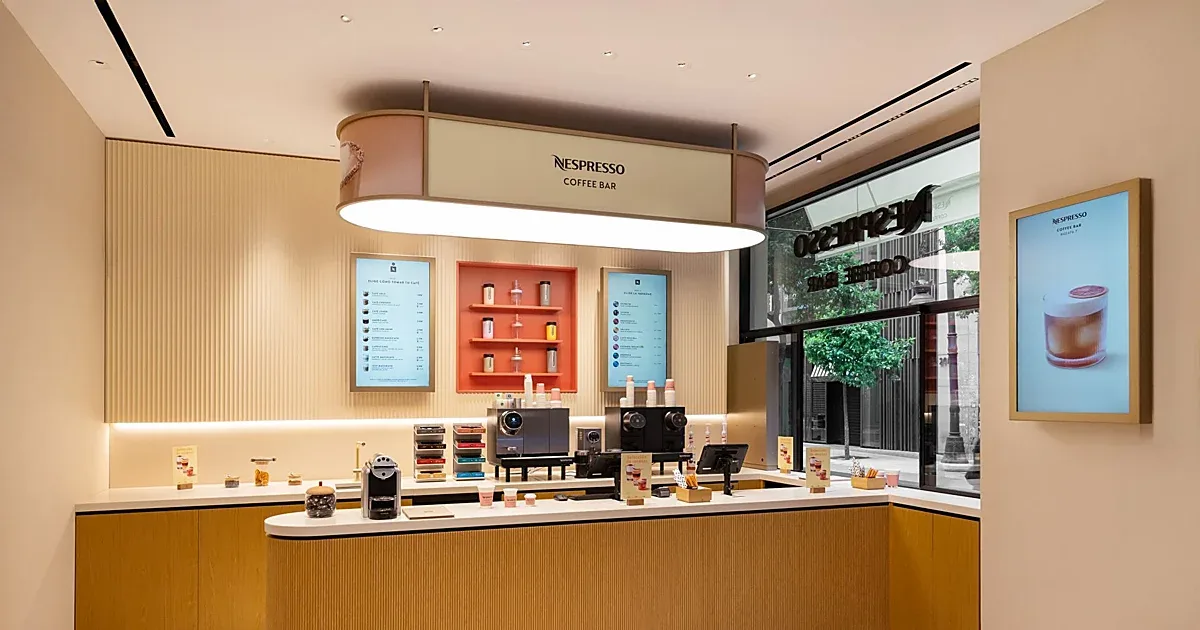 nespresso coffee bar with warm wood finishes and modern minimalist design aesthetic., boutique nespresso aqua, valència
