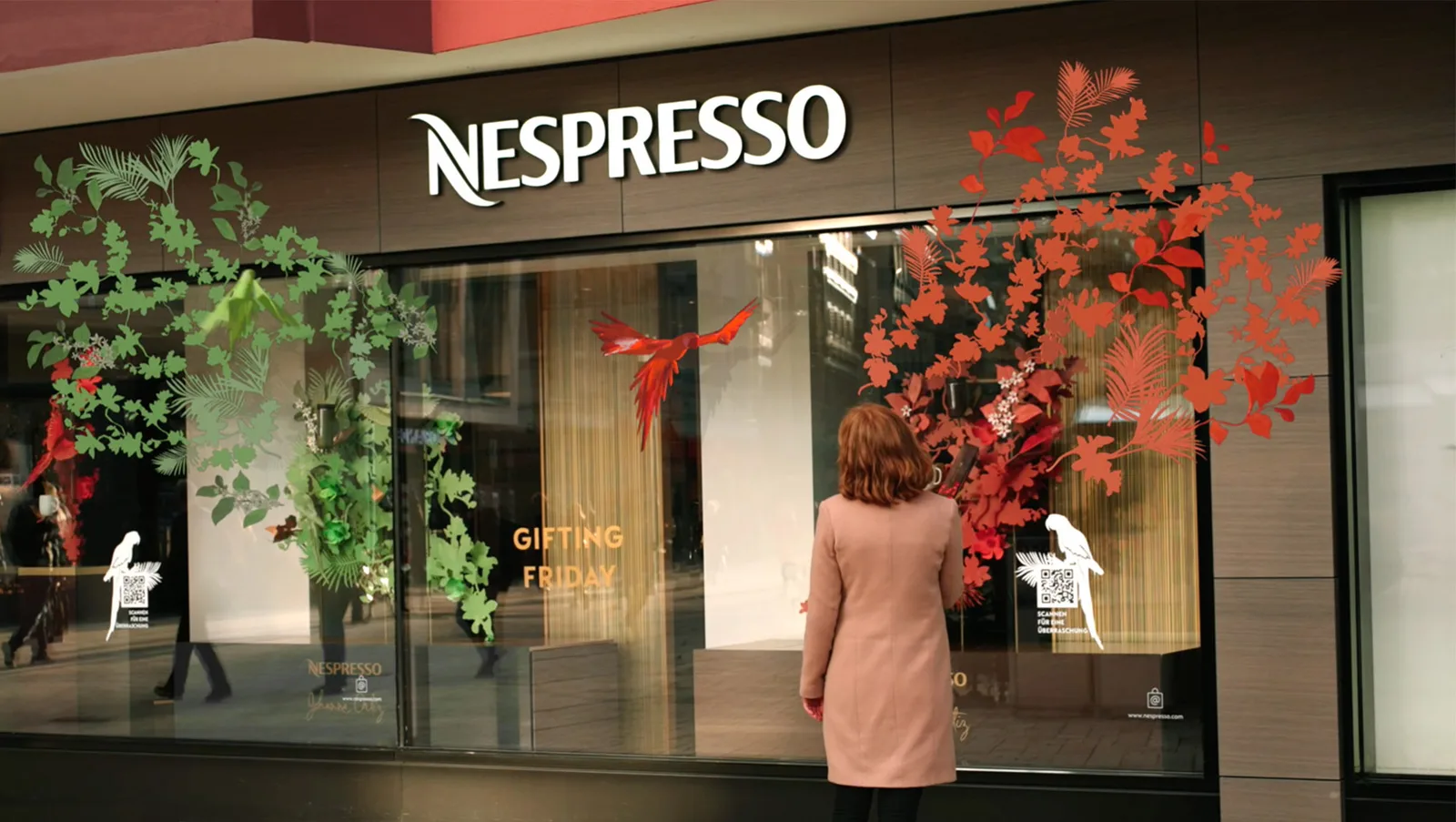 nespresso storefront with decorative red and green foliage, woman viewing window display., boutique nespresso, arese