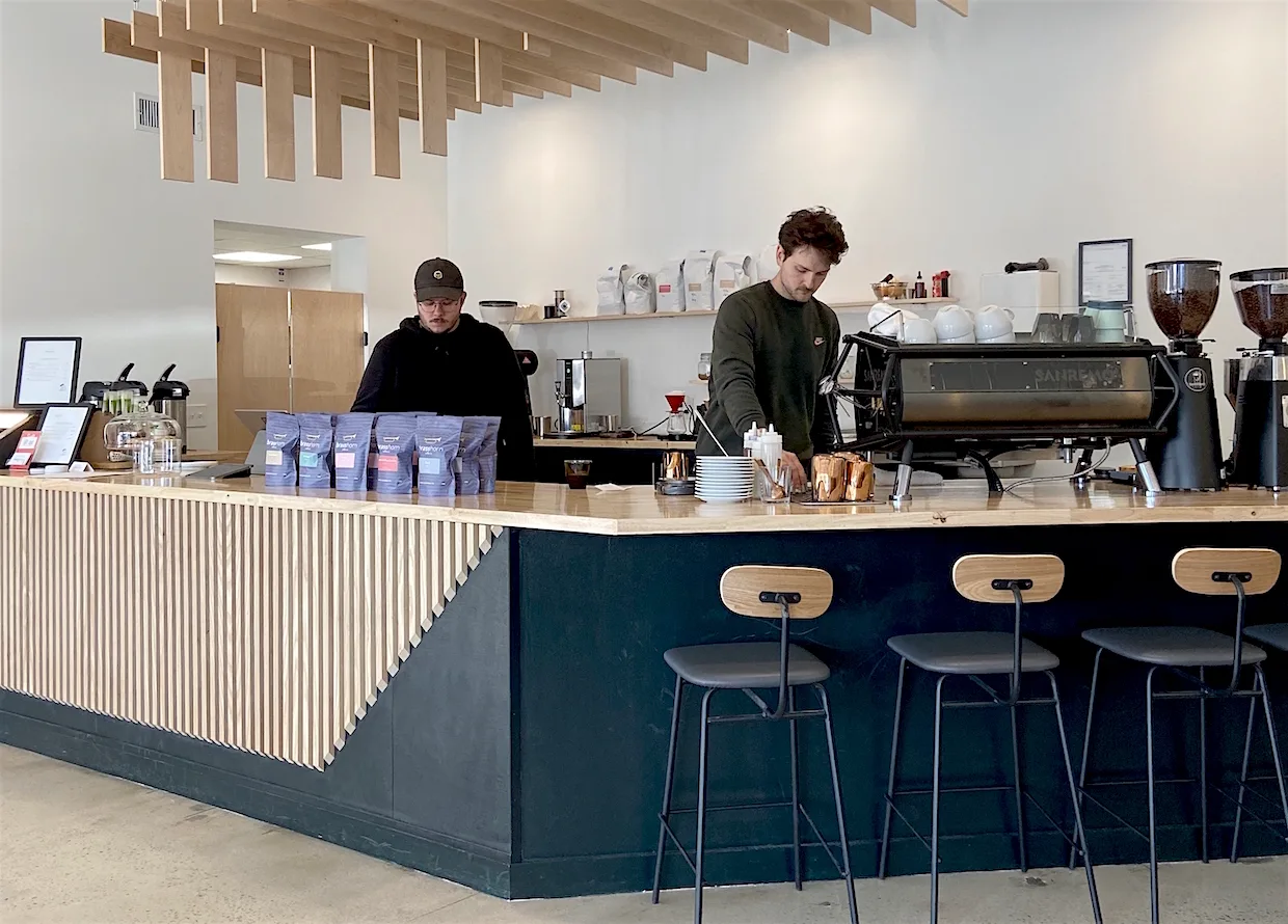 modern coffee shop interior with two baristas working behind counter., brass horn coffee roasters, murfreesboro