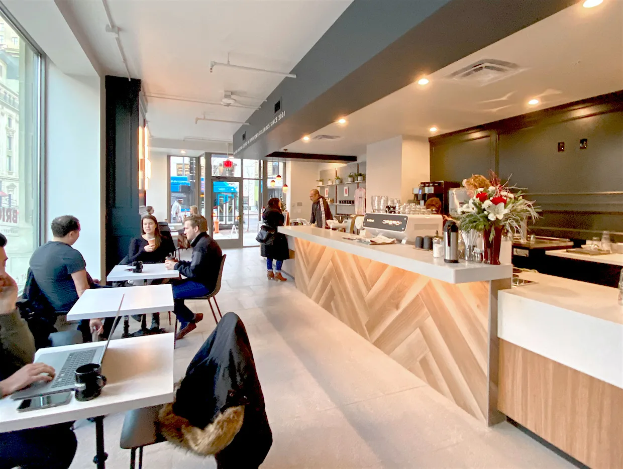 modern café interior with counter, seating, customers, and street-facing windows., brioso roastery & coffee bar, columbus
