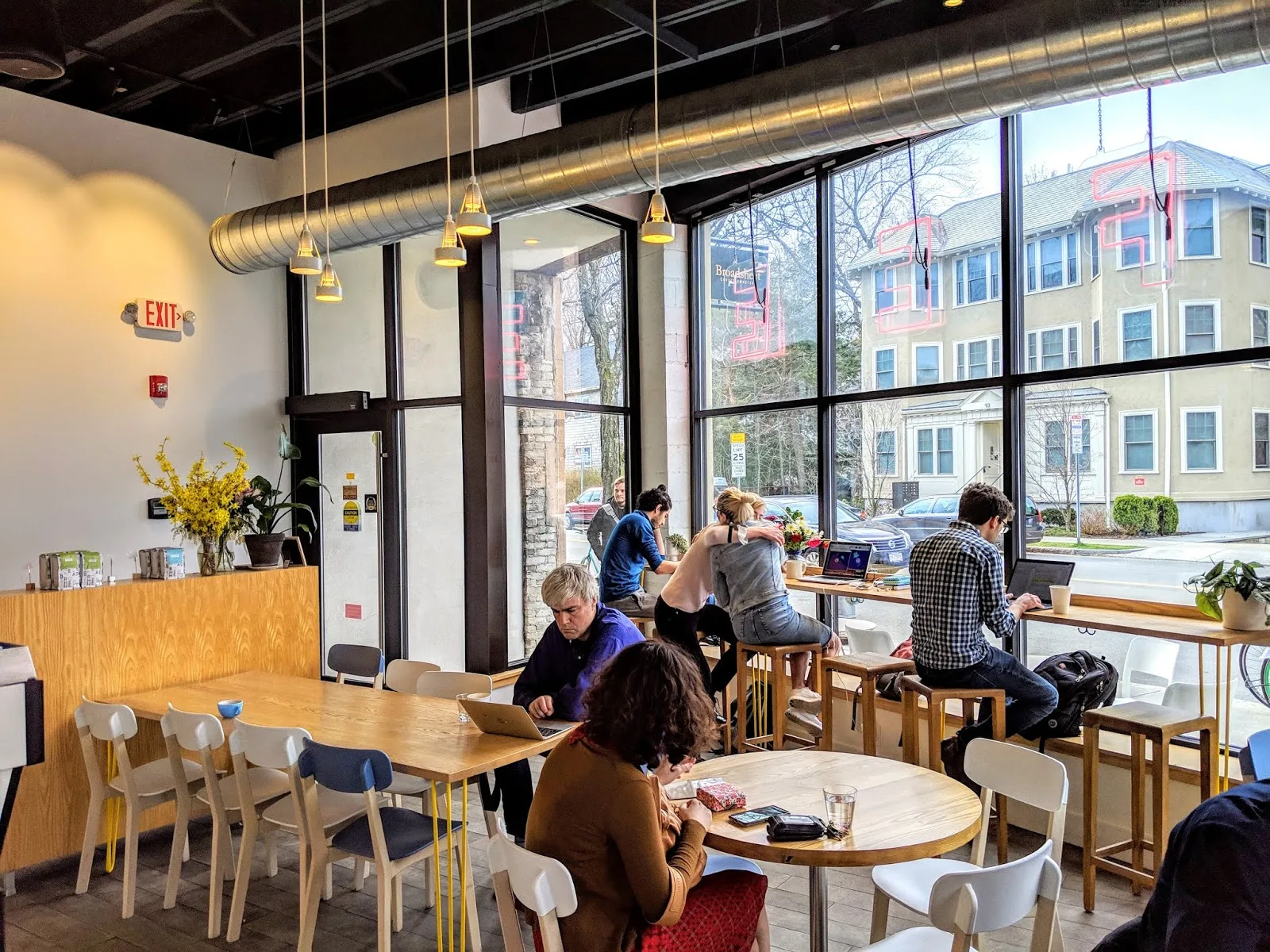 modern café interior with customers working on laptops at wooden tables., broadsheet coffee roasters, boston