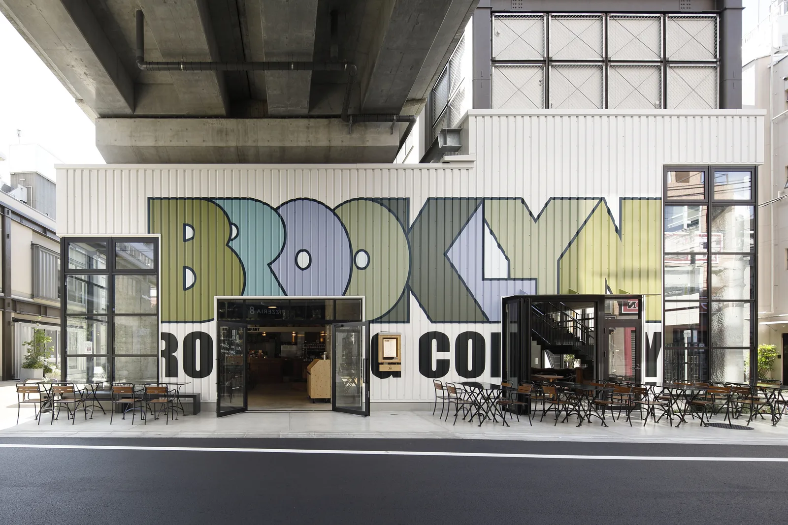 modern storefront with colorful geometric signage and outdoor seating area., brooklyn roasting company, brooklyn