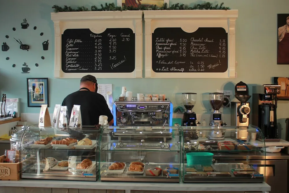 cozy café counter with pastries, espresso machine, and handwritten menu boards., brûlerie élixir, gatineau