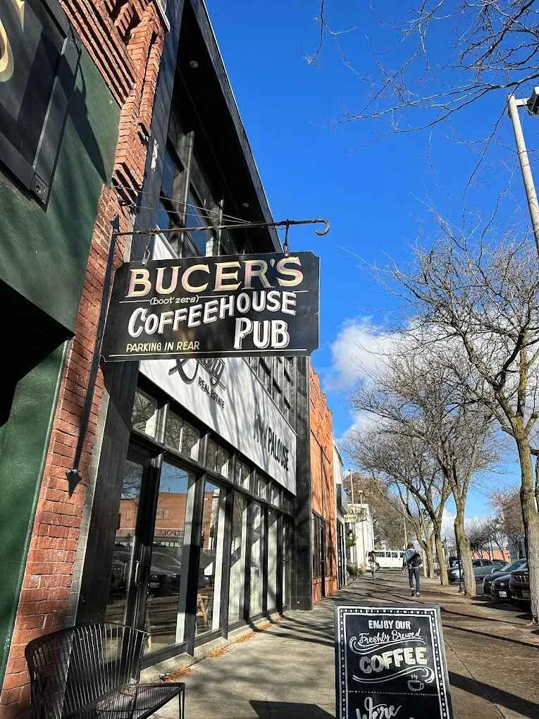 bucer's coffeehouse pub storefront on brick street with bare trees and clear blue sky., bucer's coffee house pub, idaho