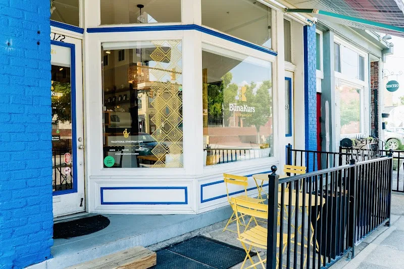 storefront with blue trim, yellow chairs, black railing, and large windows., bunakurs, richmond